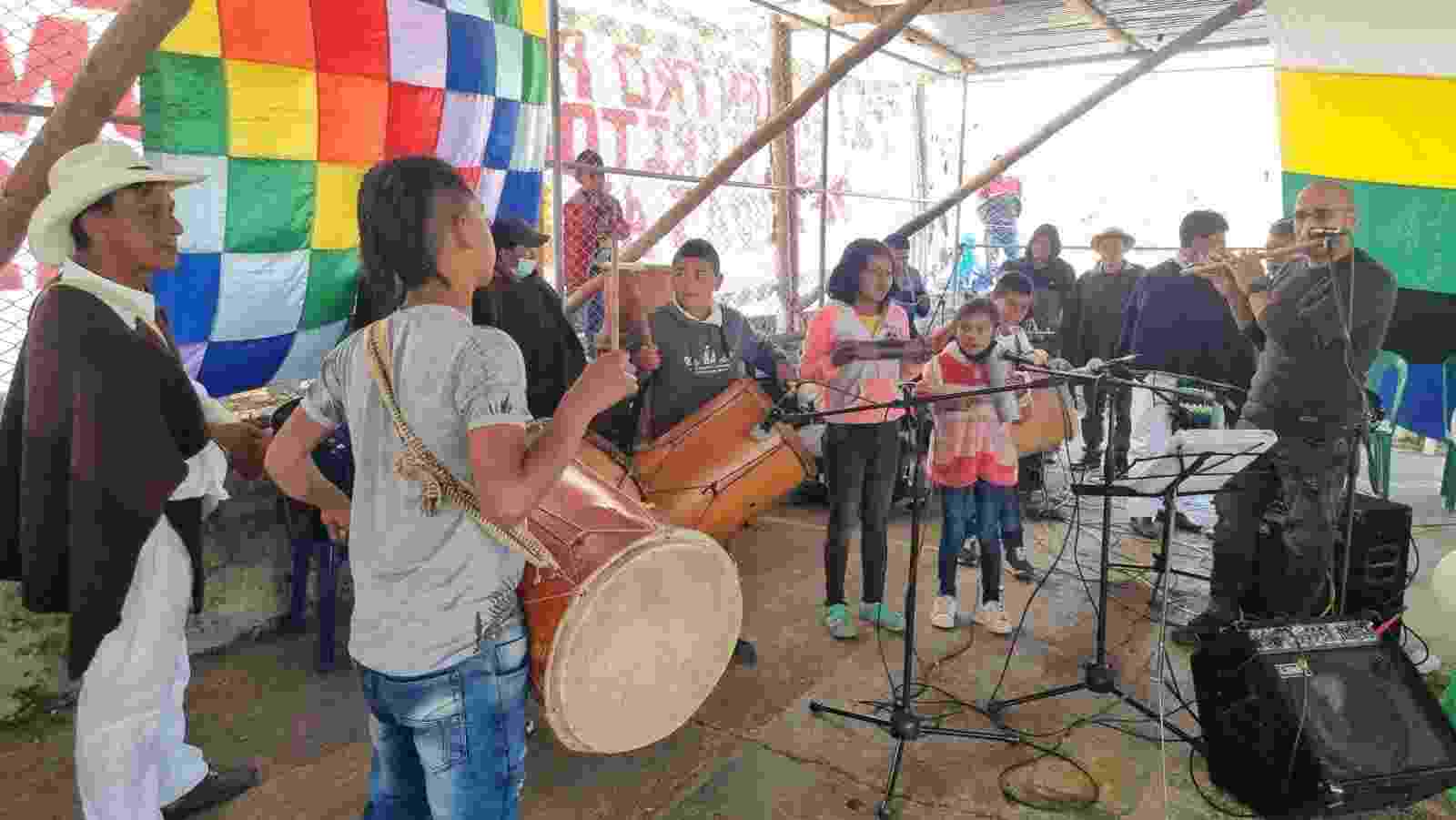 Image shows members of the Kisgó reservation celebrating with music and singing, with brightly coloured decorations